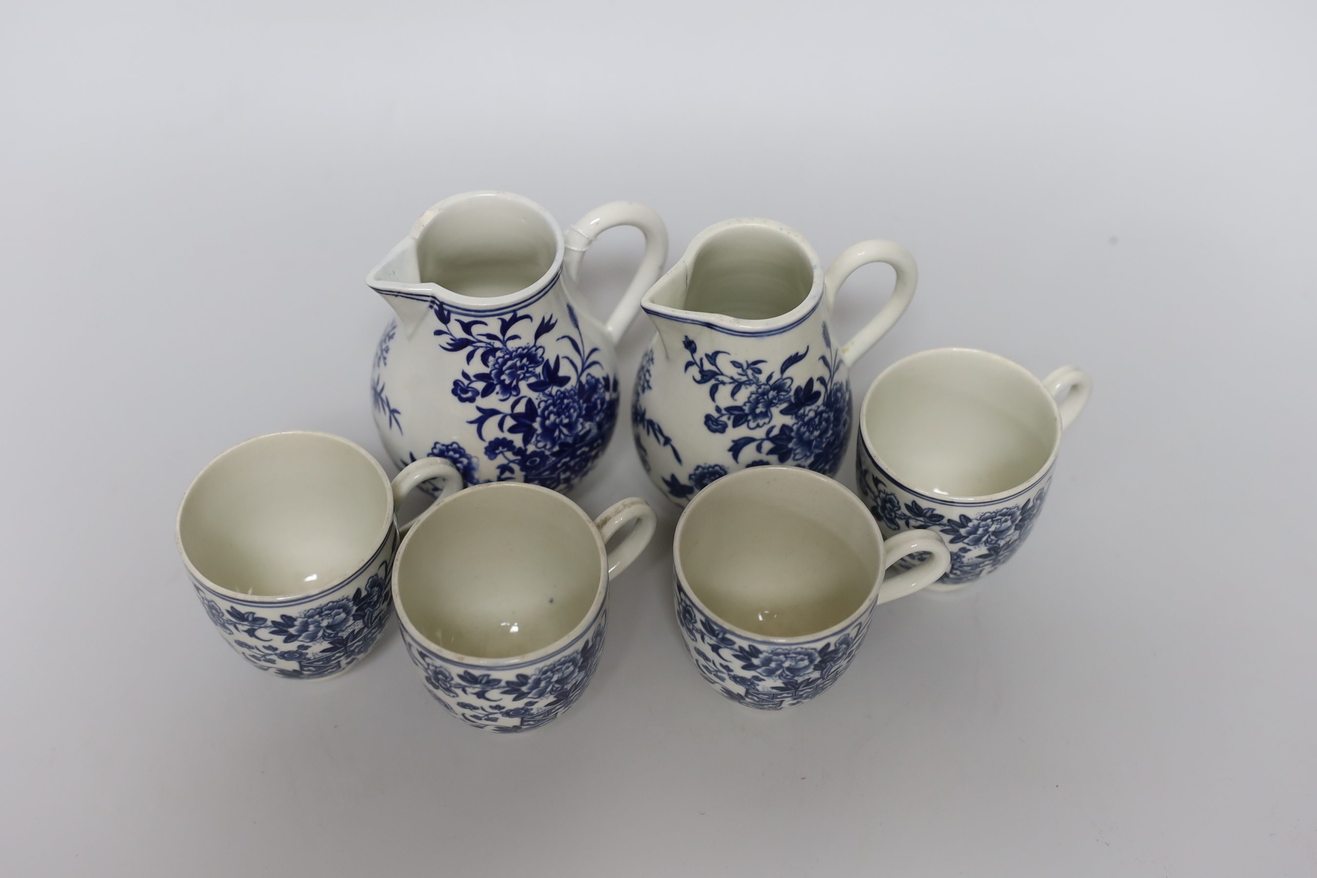 A Worcester sparrowbeak jug printed with the Fence pattern, another sparrowbeak similar and four Worcester coffee cups all printed with the Fence pattern